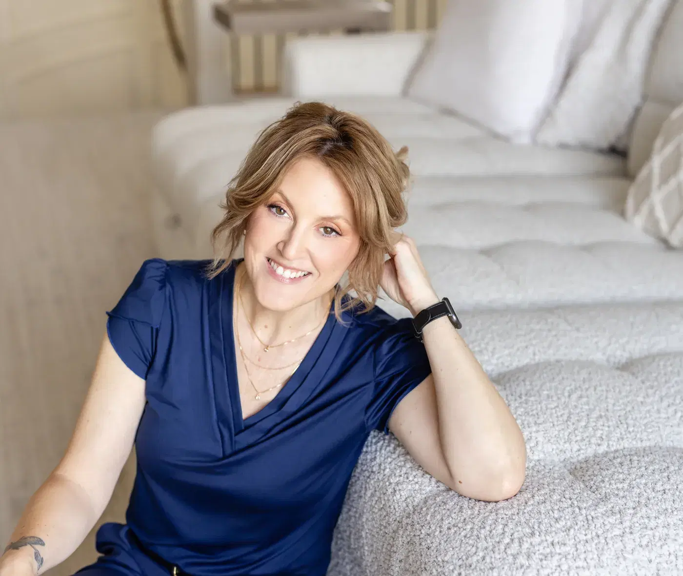 Angela Fawcett, MSW, RSW, seated on a sofa at home